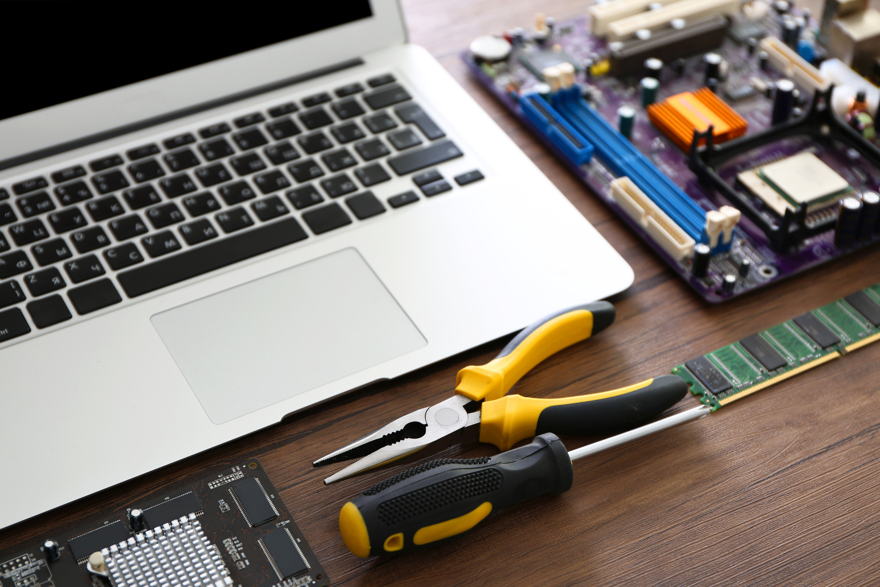 a laptop, a pair of pliers, and other tools on a table Generation Solutions IT Services Kampala Domain Name registration Kampala  DNS Hosting Web, Application, Database Hosting, Web Design and Development Email Hosting, Web Hosting Microsoft 365 Tele